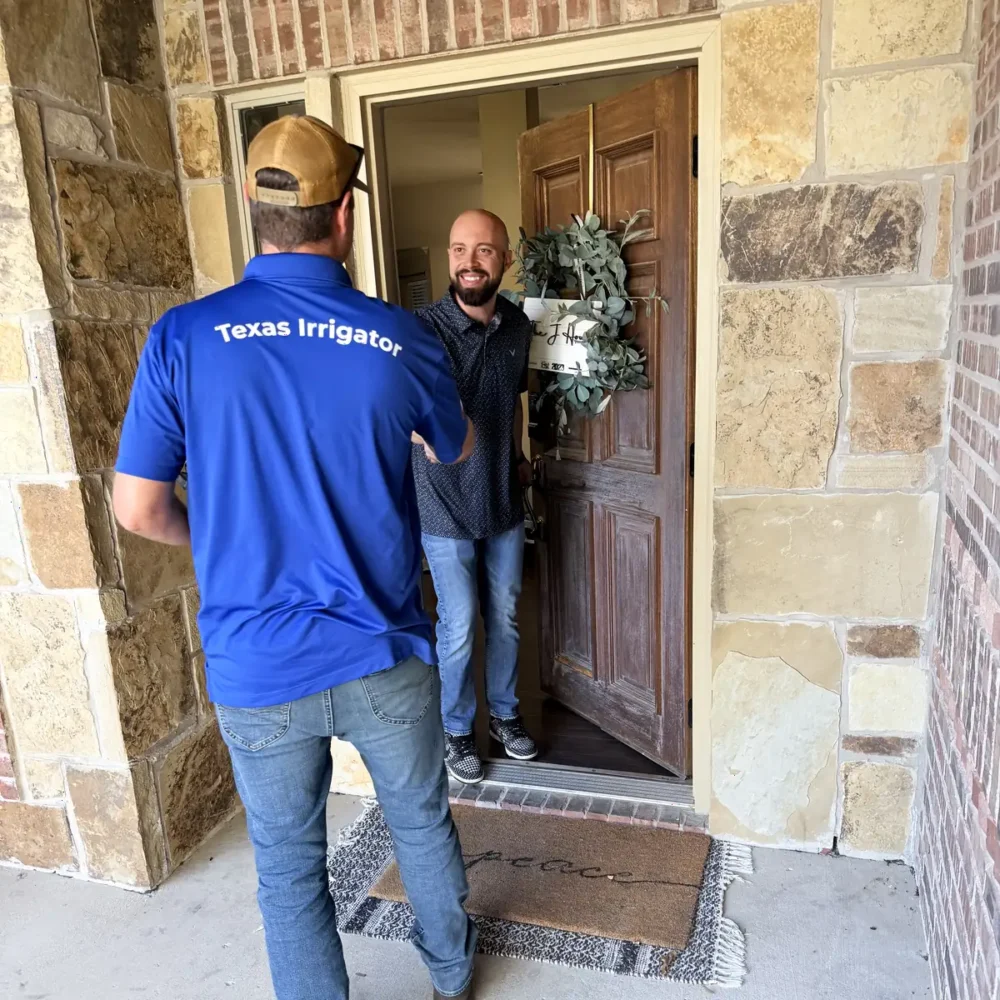 Homeowner opening the front door to a Lone Star Irrigation technician