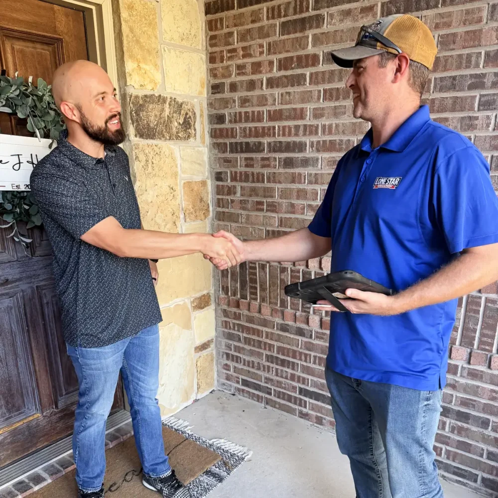 Lone Star Irrigation technician shaking hands with a homeowner at the front door