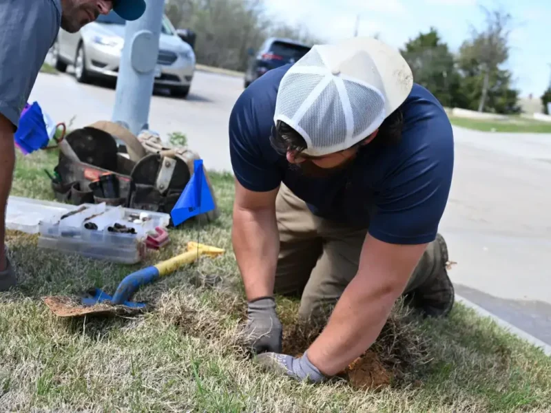 Lone Star Irrigation technician installing a sprinkler head in a lawn