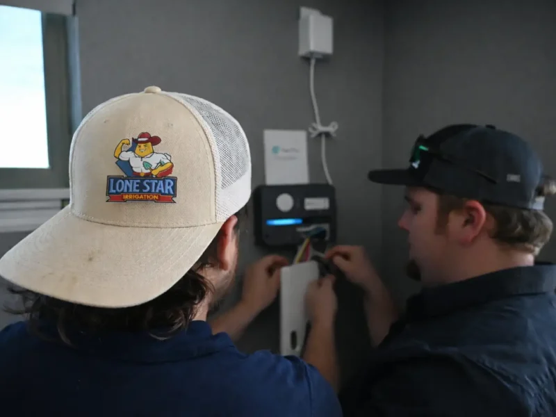 Lone Star Irrigation technicians diagnosing a sprinkler controller